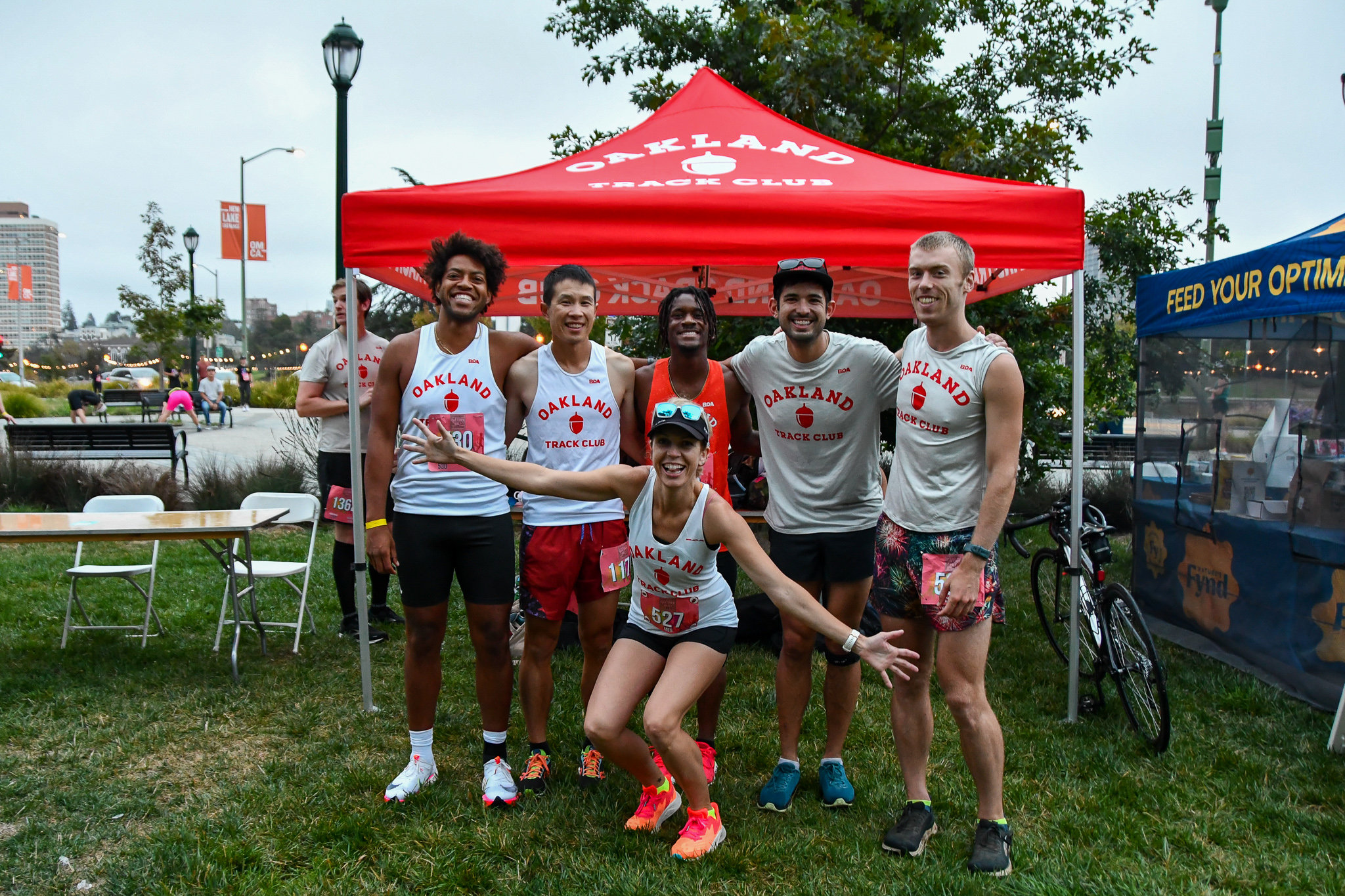 Oakland Track Club members in team singlets at the club tent